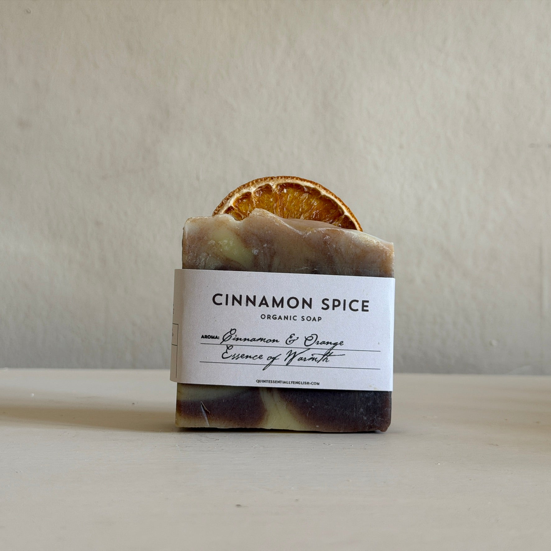 Cinnamon spice organic soap with a slice of orange on a neutral background made in Lacock Wiltshire